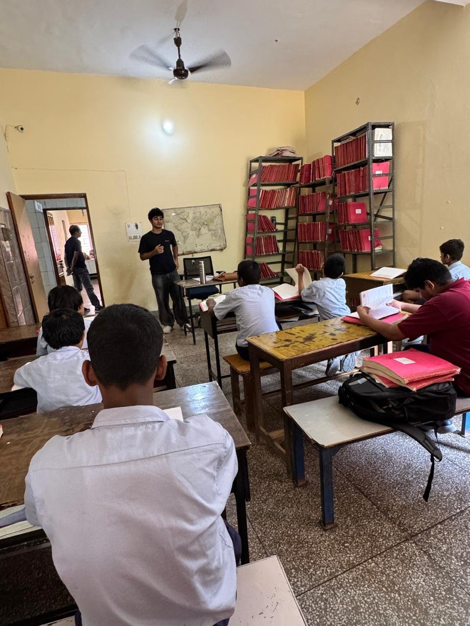 Continuing the lesson with students engaged in their braille textbooks around the room