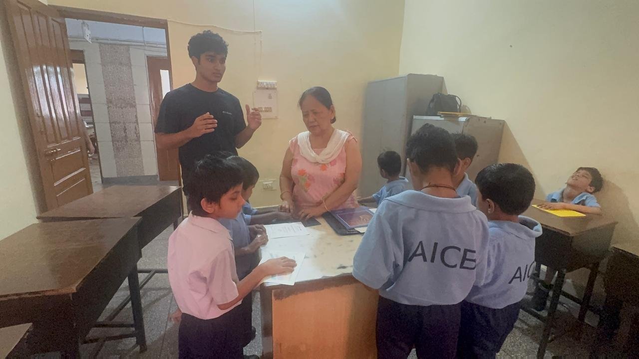 Speaking with the school's principal, Meena Aneja, as students in AICB uniforms gather around