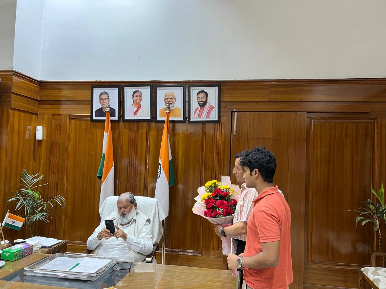 Presenting the bouquet to Anil Vij at his desk