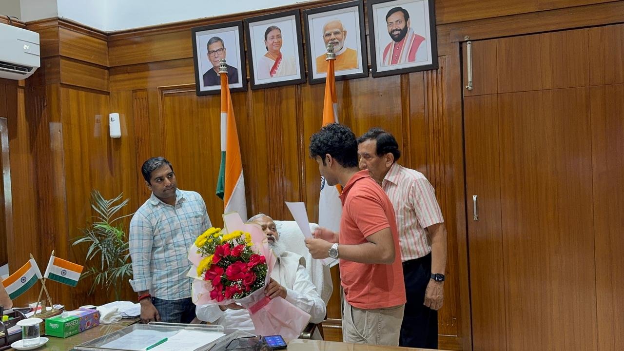 Standing around Anil Vij's desk with officials during the meeting