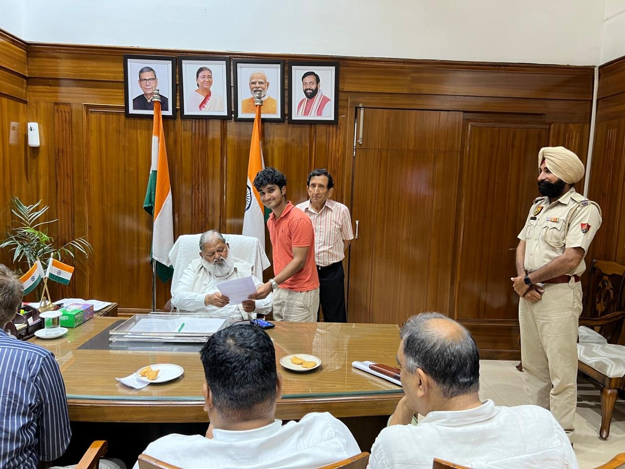 Anil Vij handing back the signed petition