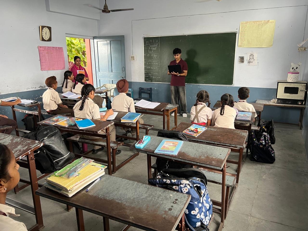 Continuing the workshop with students seated at their desks around the room
