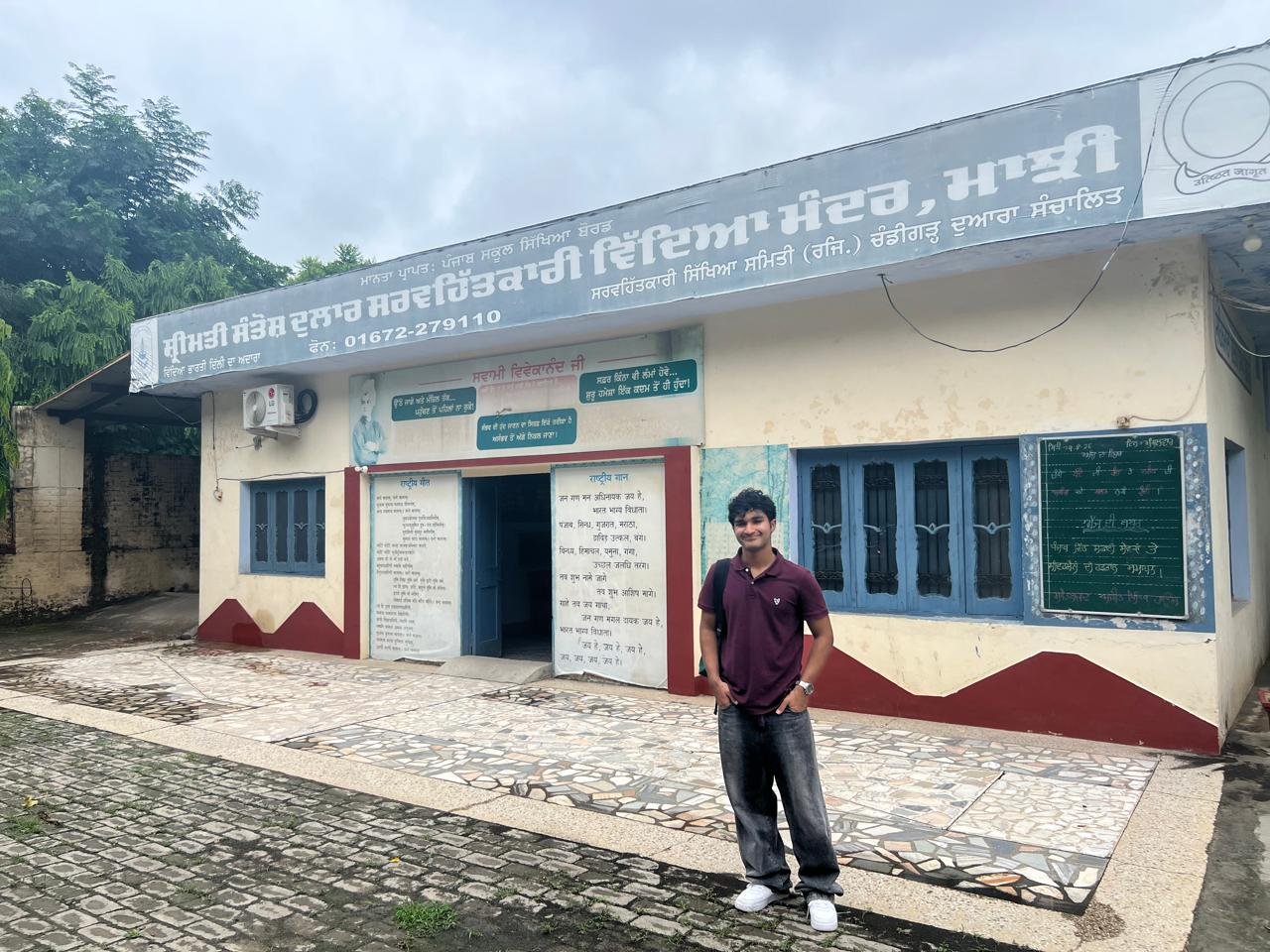 Standing outside the entrance of SMT Santosh Dular Sarvhitkari Vidya Mandir